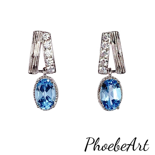 Skype Blue Topaz Earrings: Oval Cut, 18k Gold Plated Sterling Silver